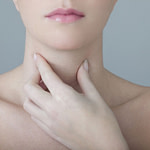 Woman touching her Thyroid
