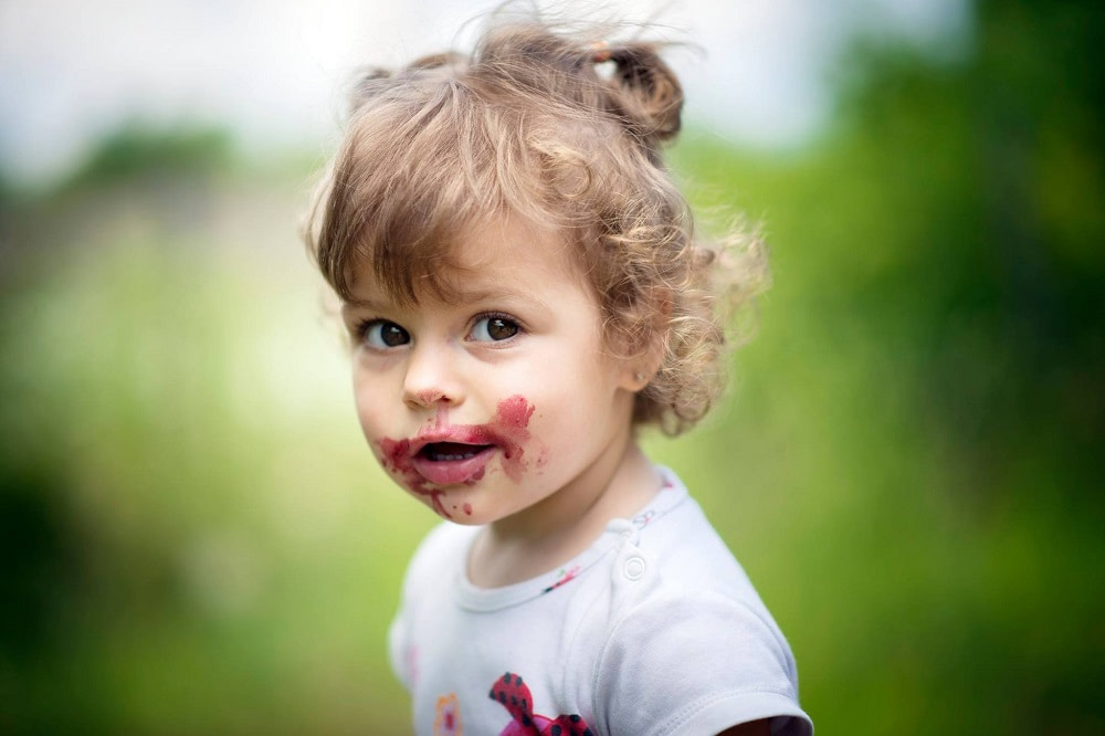 Child with messy face from food