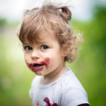 Child with messy face from food