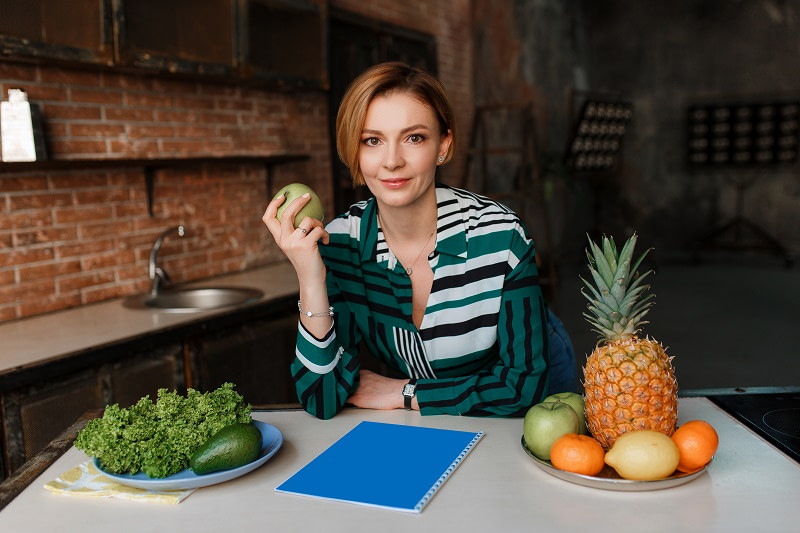 Woman in kitchen with healthy foods