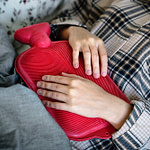 Woman with a hot water bottle on her stomach